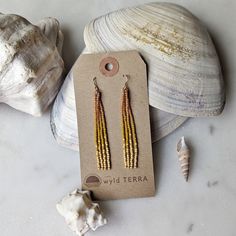 The most dreamy sun kissed inspired color combination! These earrings have the most gorgeous peachy and lavish gold feel to them. Inspired by those sunny days at the beach when the sun is reflecting off the water like diamonds. The same beaded fringe earrings you love in a shorter style. Perfect for those days when you are more active, out exploring nature! These earrings are very lightweight. A more playful, free flowing option to studs. Featuring 4 strands of hand woven matte and frosted glass Gold Dangle Tassel Earrings For The Beach, Elegant Gold Tassel Earrings For Beach, Gold Tassel Drop Earrings For Summer, Dangle Earrings With Tiny Beads For Beach, Beaded Fringe Dangle Jewelry For Beach, Beach Dangle Jewelry With Beaded Fringe, Orange Drop Earrings For The Beach, Orange Drop Earrings For Beach, Gold Dangle Chandelier Earrings For Summer