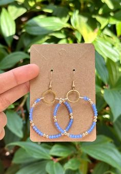 Size Drop Length 2.36 in Small circle 0.47 in Diameter of the loop 1.53 in Bright Periwinkle Blue Dangle Hoop Earrings  This delicate memory wire hoop earring is modestly sized and exudes elegance. It features a classy blend of bright periwinkle blue and golden beads meticulously strung together, forming a captivating design. The beads are skillfully looped around the wire, creating a charming and girly accessory. To ensure both strength and extra dangle, the design is completed with a small golden circle to which the beads are securely hooked. The bright periwinkle color not only adds a pop of vibrancy but also symbolizes a sense of beauty and versatility, making it a perfect choice for various occasions. Bright Periwinkle, Pageant Earrings, Hoop Earrings Handmade, Wire Hoop Earrings, Golden Beads, Periwinkle Color, Blue Crystal Earrings, Prom Earrings, Golden Circle