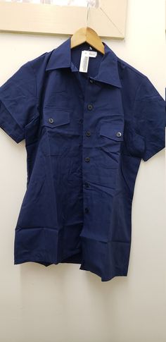 Vintage Military Issued US Navy Short Sleeve Blue Utility Shirt Size-Medium NSN# 8410-01-117-8703 Dated-2000 Condition-NEW with Tags Polyester/Cotton Made in USA!! check us out at www.armysurpluswarehouselexington.com Navy Short Sleeve Tops With Button Closure, Blue Short Sleeve Tops With Snap Buttons, Blue Short Sleeve Top With Snap Buttons, Cotton Short Sleeve Uniform Tops, Uniform Style Cotton Tops With Short Sleeves, Cotton Uniform Tops With Short Sleeves, Navy Short Sleeve Shirt With Buttons, Navy Workwear Tops With Button Closure, Navy Button Closure Top For Work