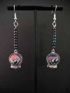 Glimpse into the future with these "crystal" ball earrings.  Charm has an iridescent sheen, beads are oil slick and change color with each movement. Crystal Ball Halloween, Crystal Ball Earrings, Ball Earrings, Oil Slick, Into The Future, Halloween Earrings, Crystal Ball, Color Change, Jewelry Earrings Dangle