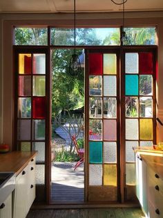 an open kitchen door with colorful glass panels