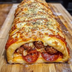 a large piece of pizza sitting on top of a wooden cutting board