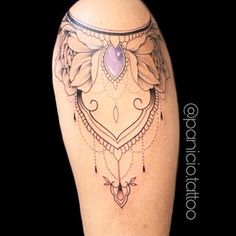 a woman's leg with an ornate tattoo design on the thigh and lower half