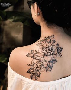 a woman with a flower tattoo on her back shoulder