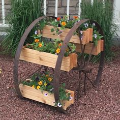 three tiered wooden planter with flowers in it