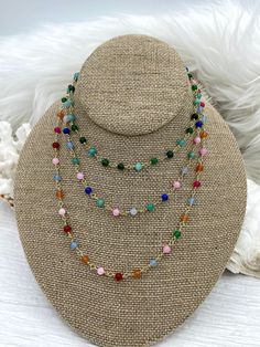 Are you looking for a unique way to add a splash of color to your jewelry designs? Our Colorful Stone Beaded Rosary Chains are the perfect way to do just that! Each chain is made with 4.5mm stone beads on gold wire and comes in 4 different styles. Style #1 features mixed green stone beads, style #2 features green, pink, and blue stone beads, style #3 features pink, red, orange, green, and blue stone beads, and style #4 features light blue stone beads. Each chain is sold by the foot, so you can g Multicolor Beaded Chain Jewelry With Round Beads, Multicolor Round Beaded Chain Jewelry, Multicolor Crystal Necklaces With Beaded Chain, Multicolor Crystal Necklaces With 8mm Round Beads, Multicolor Oval Bead Necklaces 8mm, Multicolor Oval Beads Necklace With 8mm Beads, Multicolor Necklaces With 8mm Oval Beads, Multicolor Beaded Chain With Round Beads, Multicolor Round Beaded Chain Beads