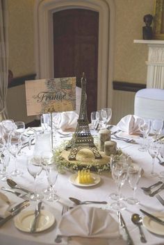 the table is set with wine glasses, silverware and place settings for an event