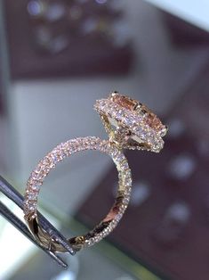 a diamond ring is on display in a glass case