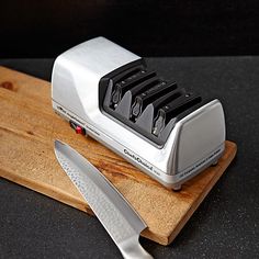 a kitchen knife and toaster on a cutting board