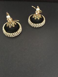 These are purely handmade dangling chandelier style earrings in silk thread wrapped jumka .available in 2 colours black / blurb silk thread with pearl & gold hooks earrings  Kindly specify which one you wish to buy when you place your order  These are an authentic Indian traditional earrings that could be worn by both traditional and an western attire. Note: The product shipped will be same as shown in the picture however, actual colours may vary slightly from those shown due to lighting in the photography. Pls note The shades of gold / silver  may vary slightly. We do not accept any returns or refunds.However in case of any issue we will definitely try and resolve it! Elegant Black Danglers For Festive Season, Elegant Black Danglers For Festive Occasions, Elegant Black Festive Earrings, Elegant Festive Black Earrings, Elegant Black Earrings For Festive Occasions, Black Earrings For Wedding And Festive Occasions, Festive Elegant Black Earrings, Festive Black Wedding Earrings, Black Chandbali Earrings For Wedding