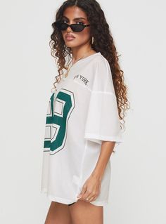 Top Graphic print, v-neckline, cap sleeves, oversized fitting, sheer  Non-stretch material, unlined  87% nylon 13% elastane  Cold gentle machine wash Oversized Sporty V-neck Top, Sporty Oversized V-neck Top, Oversized V-neck Sporty T-shirt, Oversized Sporty V-neck T-shirt, Sporty Oversized V-neck T-shirt, Oversized V-neck Top With Graphic Print, Retro Sports, Basic Shorts, Sports T Shirt