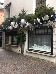 a building with christmas decorations on the windows