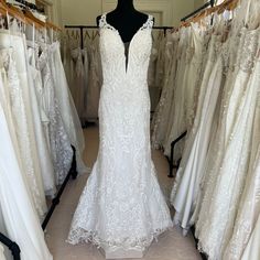 there is a dress on display in the store with other wedding gowns and bridal gowns