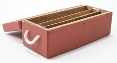 a red wooden box with three compartments and a white letter on the inside, sitting on a white surface