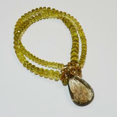 "DESCRIPTION: Thank you for coming in! A breath-takingly beautiful necklace made of an assortment of natural gemstones! You can find Lemon quartz, sunstone and a beautiful huge rutilated smoky quartz(23.6mmx37mm) in this one necklace! Premium quality gemstones finished with gold filled headpins and 18k solid yellow gold clasp! 18\" gorgeous necklace, 256 carats! You'll get the necklace you see! SIZE: 23.6mmx37mm center stone. GRADE: Transparent COLOR: Multi" Faceted Briolette Citrine Jewelry, Luxury Faceted Amber Jewelry, Luxury Smoky Quartz Jewelry Gift, Faceted Citrine Briolette Necklace, Cluster Necklace, Sky Blue Topaz, Lemon Quartz, Beautiful Necklace, Gorgeous Necklaces