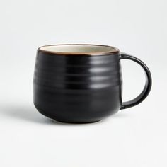 a black and white coffee mug on a white background with a brown stripe in the middle