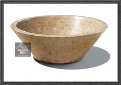 a large stone bowl sitting on top of a white table next to a black frame