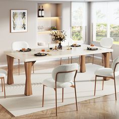 a dining room table with white chairs around it