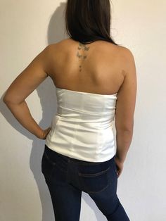 "White Embroidered Corset Top Boned Bodice Strapless Top Sweetheart Bust Steampunk Size Medium Estimated size: M Material: 97%Polyester; 3%Elastane Linning: 100%Polyester Measurements: (lying flat) Lengt: 15\" / 38 cm Pit to pit: 16\" / 40.5 cm Waist: 15\" / 38 cm Please check measurements to insure a proper fit. Remember to allow yourself some extra room for movement. You can compare these with something from your closet that fits you well. This tops will come to you freshly laundered and ready Party Tube Top With Boned Bodice And Stretch, Party Stretch Tube Top With Boned Bodice, Stretch Tube Top With Boned Bodice For Party, White Fitted Corset For Club, White Fitted Corset For Club Wear, White Corset For Club, Bandeau Halter Top For Clubbing, Sleeveless Boned Bodice Top For Club, Sleeveless Club Tops With Boned Bodice