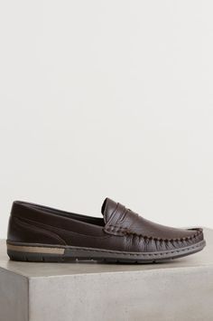 Men’s Niles Leather Moccasin Sho | Overland Brown Moc Toe Slip-ons For Fall, Brown Swift Leather Slip-ons With Textured Sole, Comfortable Leather Moc Toe Slip-ons, Slip-on Swift Leather Loafers With Moc Toe, Leather Moccasins With Textured Sole For Business Casual, Leather Moc Toe Slip-on Loafers, Leather Moc Toe Slip-ons With Leather Footbed, Brown Slip-on Loafers With Stitched Sole, Business Casual Leather Moccasins With Leather Footbed