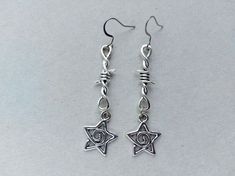 The earrings are decorated with star-shaped brass pendants. The earrings are fastened with stainless steel hookss. Earring length - 6.0 cm (2.4 inches) Earrings are packed in a gift box RECOMMENDATIONS FOR CARE: Do not wet, do not drop, and store in a dark box! - Remove jewelry before exercising, swimming, showering and sleeping. - Avoid contact with moisture such as make-up, moisturizer, lotion, perfume and hairspray. - Store your jewelry in a box or pouch after use. Grunge Jewellery Earrings, Punk Style Star-shaped Metal Earrings, Edgy Star-shaped Pierced Earrings, Grunge Star-shaped Jewelry Gift, Nickel-free Metal Earrings In Grunge Style, Nickel-free Metal Grunge Earrings, Gothic Silver Star Earrings, Silver Star Gothic Earrings, Silver Pierced Grunge Earrings