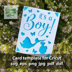 a card with the words it's a boy on it next to some flowers