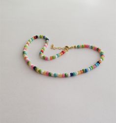 "The Dainty Colorful Beaded choker is great for summer and in the beach. It is made with small Japanese glass beads. This Beaded Choker can be perfect to wear everyday. This listing for ONE CHOKER. DETAILS - Japanese glass seed beads 4 mm - Quality strong nylon string - Choker length. Choose in the drop down menu - Lobster or round clasp closure. Available gold tone (default) or silver tone (by request) - Extension (adjustment) is 1 inch (2.5 cm). If you need longer, please, leave a note when or Summer Spacer Bead Choker Jewelry, Adjustable Letter Beads Choker, Trendy Round Beads Choker For Festivals, Vacation Colorful Beads Choker, Beaded Chain Choker For Beach, Beach Choker With Round Beaded Chain, Trendy Handmade Beads Choker, Trendy Festival Beaded Choker Necklace, Adjustable Bohemian Letter Beads Choker