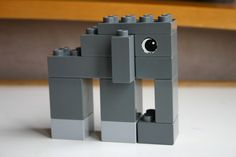 a gray lego dog is standing on the floor