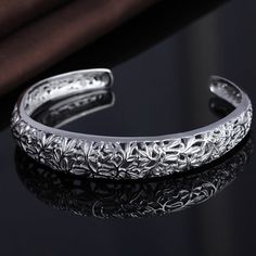 This stunning bangle bracelet is crafted from high-quality White Gold plating and features an intricate filigree flower design. The bracelet has a unique and delicate appearance, with a slim band that is comfortable to wear on the wrist. The filigree flower is beautifully detailed and adds a touch of elegance and charm to the piece. The bracelet is adjustable to fit most wrist sizes, making it a perfect gift for someone special. Its timeless design makes it a versatile accessory that can be worn Sterling Silver Filigree, Gold Filigree, Silver Filigree, Silver Roses, Silver Rose Gold, Gold Material, Flower Design, Girls Shopping, Gold Plating