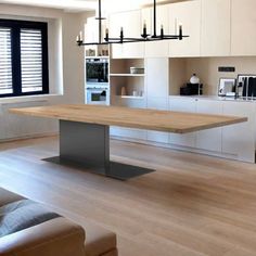 a large wooden table sitting in the middle of a living room