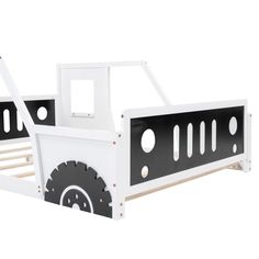 a white and black truck bed with wheels on the bottom bunk, it is made out of wood