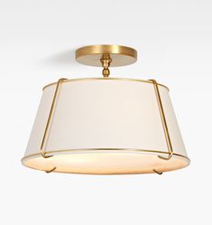 a light fixture with a white shade hanging from the ceiling