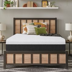 a bed with a wooden headboard and pillows on top of it in a room