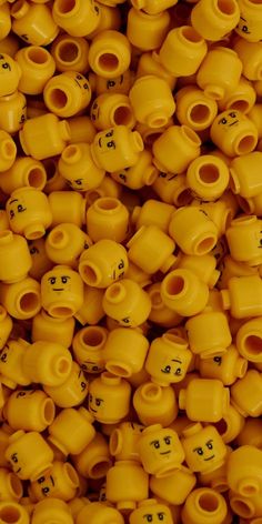 many yellow vases with faces on them are arranged in the shape of letters and numbers