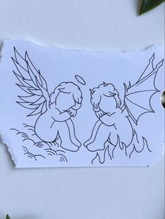 a piece of paper with a drawing of two cherubs and leaves on it