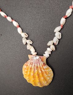 A lovely single strand of native endemic Laiki shells (rice shells) from the forbidden Island of Niihau combines with bright pink Kahelelani shells and Momi shells with a central pendant Hawaiian Sunrise Shell.  This style is referred to as Kipona or straight styel of stringing the shells together. All shells are 100% Niihau shells except the Hawaiian Sunrise shell. This Hawaiian Shell Lei is 23" long. extra-large Hawaiian Sunrise Shell embellished with a 1/2 K CZ.   with lots of pink highlights Niihau Shells, Sunrise Shell, Ocean Treasures, Pink Highlights, Puka Shell, Shell Necklace, Shell Jewelry, Shell Necklaces, Simply Beautiful