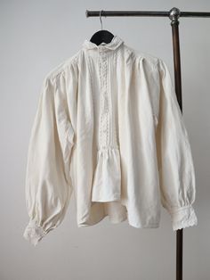 C1930s Transylvanian folk blouse. Acquired from my travels in the Carpathian Mountains.  Homespun linen. A really lovely zig zag details down the front. White glass buttons. Trapeze shape with balloon sleeves. A really wonderful example of this style of traditional men's folk blouse which would have been worn with wide cropped linen trousers.  Measures: 25" underarm to underarm, 9 1/2"   from shoulder to underarm, 24" sleeves, 17 1/2" across the shoulders, 23" long in the body, 14"  collar Great Vintage Linen Blouse For Fall, Cotton Ruffle Blouse For Gatherings, Folk Style Long Sleeve Linen Tops, Vintage Long Sleeve Linen Blouse, Vintage Linen Long Sleeve Blouse, Vintage Long Sleeve Blouse For Gatherings, Vintage Style Tops For Spring Gatherings, Vintage Tops For Spring Gatherings, Vintage Fitted Pre-washed Tops