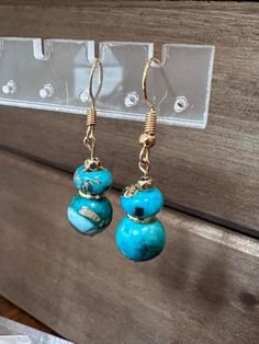 Adorn yourself with these breathtaking Turquoise Beaded Dangle Earrings, a splendid example of boho chic jewelry. Handcrafted with care, these earrings embody the essence of Southwest style, exuding a free-spirited charm. The vibrant turquoise beads add a pop of color and personality to any outfit, making them a versatile accessory for everyday wear or special occasions. Each pair is a unique piece of handmade jewelry, showcasing the artisan's dedication to detail and creativity. Elevate your style with these dangle earrings that capture the essence of bohemian flair and artistic elegance.  Check out the matching necklace and bracelets. Bohemian Blue Beaded Earrings With Natural Stones, Turquoise Beaded Round Earrings, Bohemian Turquoise Beaded Round Earrings, Turquoise Beaded Earrings With Ear Wire, Elegant Turquoise Beaded Dangling Earrings, Turquoise Round Beaded Earrings With Ear Wire, Turquoise Beaded Earrings With Natural Stones, Turquoise Wire Wrapped Beaded Earrings, Turquoise Wire Wrapped Beaded Earrings As Gift