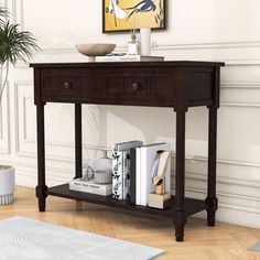 a wooden table with two drawers and a book shelf on the bottom, in front of a white wall