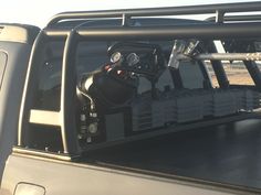 the back end of a pickup truck with its cargo compartment open and equipment in place