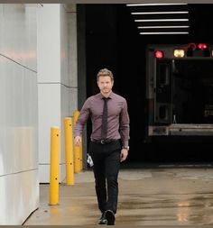 a man in a tie walking down the street