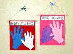 two handprinted signs hanging on a wall next to each other with the words grandpa's little buddy and grandma's little angel