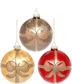 three christmas balls with bows hanging from them