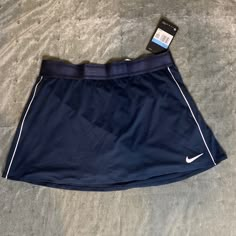 Size Medium New, Never Worn Navy Blue Nike Tennis Skirt Blue Sporty Mini Skort, Sporty Blue Mini Skort, Sporty Blue Skort, Blue Mini Skort For Sports, Nike Sports Skirt For Spring, Sporty Blue Mini Tennis Skirt, Sporty Fitted Blue Skirt, Blue Fitted Sporty Skirt, Nike Blue Skort For Spring