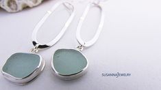 Find a gift she'll cherish. Timeless jewelry for every occasion. Our sterling silver and sea glass dangle earrings feature a long, slender modern design. OOAK pieces of surf tumbled sea glass are first chosen to coordinate, then carefully wrapped in fine silver bezel wire with an eye-catching polish. Each lengthy oval of sterling wire is shaped and hammered by artisan Susan Volger. There is a lot of movement in these earrings and they are very comfortable to wear. They dangle from a pair of ster Handmade Silver Sea Glass Earrings, Silver Sea Glass Earrings For Gift, Handmade Silver Earrings With Sea Glass, Elegant Silver Sea Glass Earrings, Beach Earrings In Silver With Recycled Glass, Silver Sea Glass Dangle Earrings, Beach Silver Earrings With Recycled Glass, Silver Sea Glass Drop Earrings, Silver Recycled Glass Earrings For The Beach