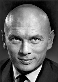 black and white photograph of a bald man wearing a suit