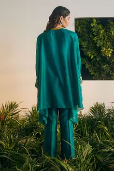 Emerald thread embroidered raglan sleeve tunic. Paired with silk chanderi wide leg pant and a short cotton slip. - Aza Fashions Eid Pant Set With Long Set-in Sleeves, Festive Palazzo Set With Set-in Sleeves For Eid, Festive Tunic Kurta With Embroidered Sleeves, Silk Embroidered Long Sleeve Tunic, Embroidered Silk Tunic With Long Sleeves, Embroidered Silk Long Sleeve Tunic, Long Sleeve Silk Embroidered Tunic, Festive Embroidered Sleeve Tunic Kurta, Festive Blouse With Embroidered Sleeves For Eid