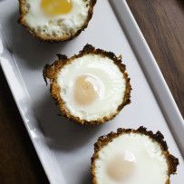 three fried eggs are on a white plate