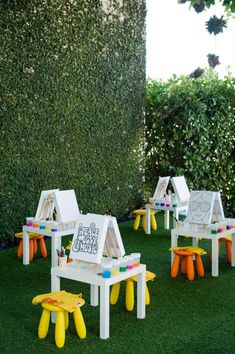 children's art tables and stools in the grass