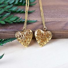 This necklace is made from a gold plated locket charm. The locket is in a shape of a simple heart and opens so you can put something special inside. The front of the locket is an intricate filigree design with cut outs. The locket hangs from a gold stainless steel chain. You can choose the style and length of the chain. Please choose the length you would like the necklace in. Please choose the chain style you would like your pendant on. Please note that all necklaces are handmade and may differ Elegant Heart-shaped Locket Charm Necklace, Elegant Heart Locket Charm Necklace, Elegant Heart Shaped Locket Charm Necklace, Dainty Double Heart Locket Necklace, Rose Gold Heart Charm Locket Necklace, Elegant Filigree Heart Pendant Locket Necklace, Rose Gold Heart Charm Pendant Locket Necklace, Elegant Heart Pendant Locket Necklace With Filigree, Heart Locket Necklace For Her